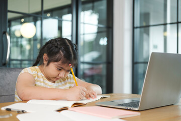 Girl children using laptop computer, studying through online. - obrazy, fototapety, plakaty