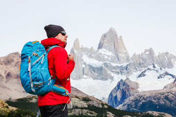 Active hiker hiking, enjoying the view, looking at Patagonia mountain landscape. mountaineering sport lifestyle concept