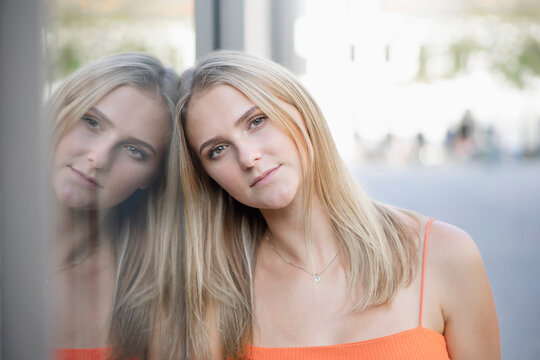 Portrait of young woman looking thoughtful into camera in Munich