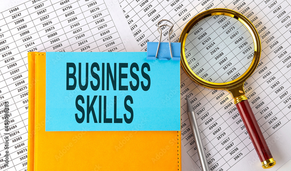 Poster business skills text on sticker on notebook with magnifier and chart. business concept