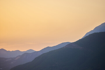Obraz na płótnie Canvas Evening sky at sunset and mountain landscape with copy space