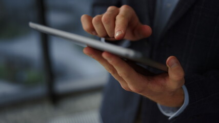 Tablet computer in unrecognizable businessman hands closeup. Man using tablet 