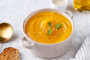 Pumpkin soup in a cup on the table