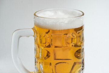 Mug of beer with foam on white background close up