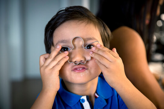 Boy holding Christmas cookie cutter