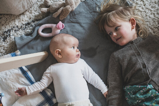 Girl with baby sibling looking at each other