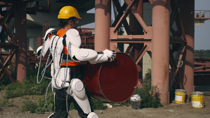 Male worker in exoskeleton delivering barrel to foreman