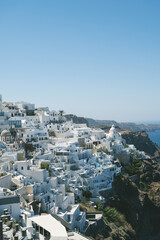 Naklejka premium Scenic cityscape of Thira. city on the hill. White architecture. Santorini island, Greece. Luxury tourism.