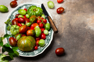 colorful organic tomatoes in a vintage plate