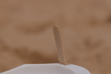 Lollipop stick poking out of a coffee cup
