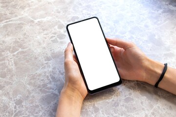 Woman using white desktop screen mobile phone on the marble table.