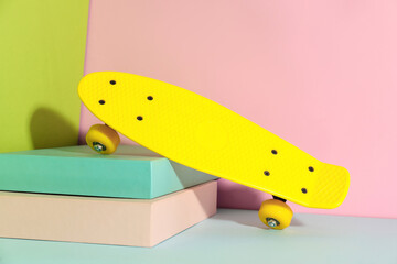 Yellow skateboard on color background. Sport equipment © New Africa
