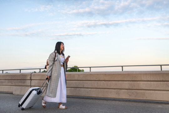 Woman walking with suitcase