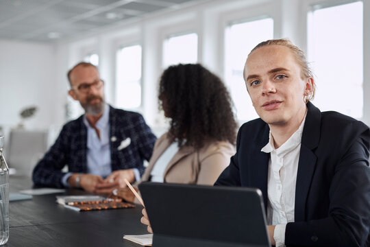 Man during business meeting looking at camera