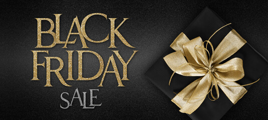 Fototapeta na wymiar gift card, Black Friday sale text and black package wrapped with golden ribbon bow isolated on black background, template for promotional banner with copy space