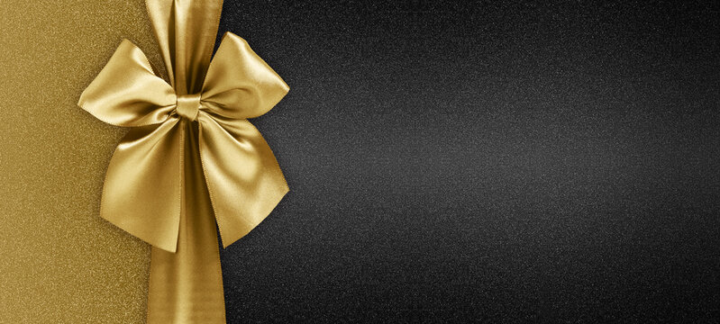 gift card with golden ribbon bow isolated on black background template with copy space for Merry Christmas or black friday promotional offer