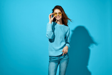 woman in a blue sweater blue background Lifestyle