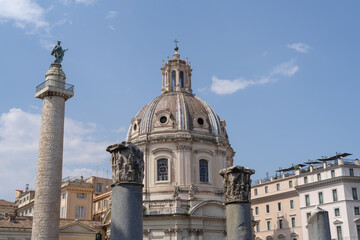 Fototapeta na wymiar Trajan's Column and church of Saints Luca and Martina, along street dei Fori Imperiali in Rome