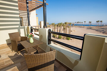 Terrace balcony with chairs in tropical luxury apartment resort