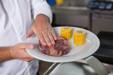 Unrecognizable chef preparing marbled beef steak for grilling