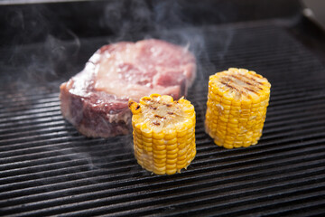 Fresh raw marbled beef grilling with sweet corn