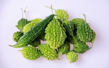 Green bitter gourd fruit on a white background