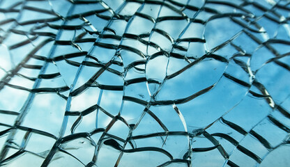 Large shattered tempered glass window pane. Cracked glass texture close up.