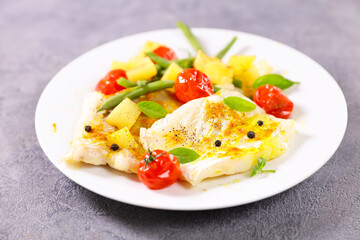 fish fillet with vegetables on plate