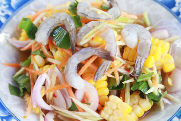 Close up spicy Raw Shrimp Salad favorite Thai food, vegetable and raw shrimp with water chilli in...