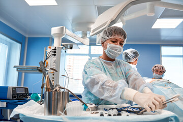 A team of surgeons fights for life, performing a complex operation in a modern operating room