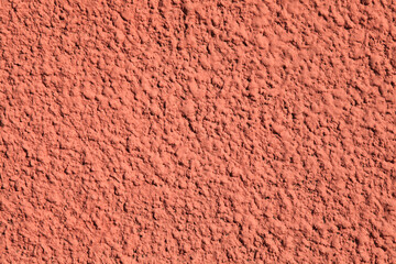Pink wall, texture, background. Relief surface. Plastered building wall, painted with water-based...