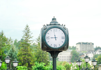 Fototapeta na wymiar Big white street clock in the city park. Dial. Selective focus