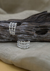 Silver jewellery setup. silver jewelry fashion photography. Silver earrings fashion photography. Earrings presented on a timber. Women accessories. Selective focus.