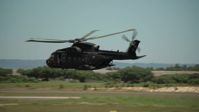 An American military helicopter flies in slow motion, near, on military exercises, over the base of the armed forces.