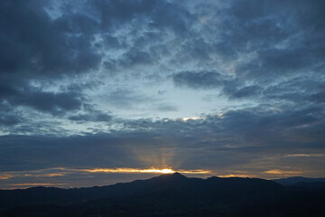 Natural landscape of green mountain range with cloudy blue sky