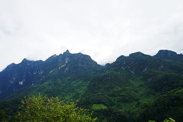 Natural landscape of green mountain range with cloudy blue sky