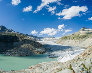 View of the head of the Rhonegletcher Glacier in Switzerland. There is a glacier lake below.