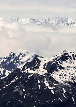 USA, Alaska, Clouds Above Snowy Mountains