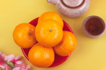 Orange put beside Chinese Tea cup on background