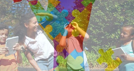Animation of colorful puzzle pieces ribbon over happy playing children - Powered by Adobe