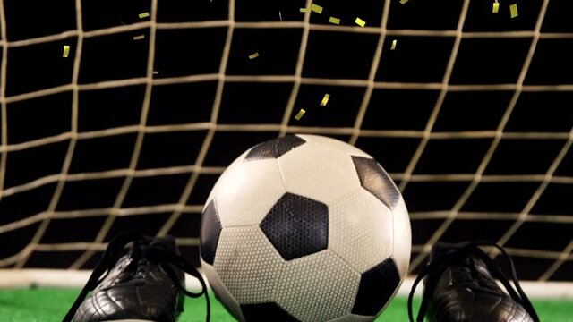 Animation of gold confetti falling over soccer ball and sport shoes