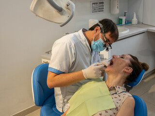 Fototapeta premium Dental clinic. Young adult woman at the dentist appointment.