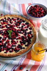 Delicious currant pie and fresh berries on kitchen towel