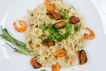 Risotto with seafood on dish, top view close-up