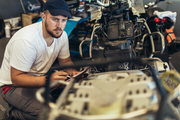 Professional motorcycle mechanic working in bike repair service