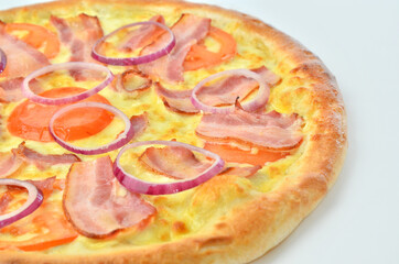 pizza with ham, onion, tomato and cheese closeup view