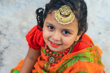 Indian little girl in traditional saree and jewelry. Cute Indian little girl in traditional wear...
