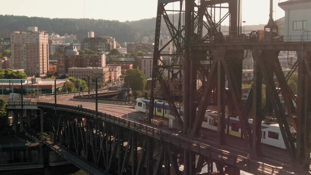 Aerial: Train crossing the Steel Bridge over the Willamette River in downtown Portland. Oregon, USA