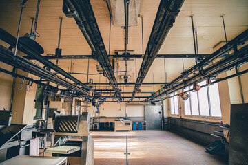 View of an empty empty slaughter house, with light closed windows, equipment and prepared machines