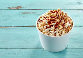 Hazelnut topping on a tub of vanilla ice cream spaghetti
